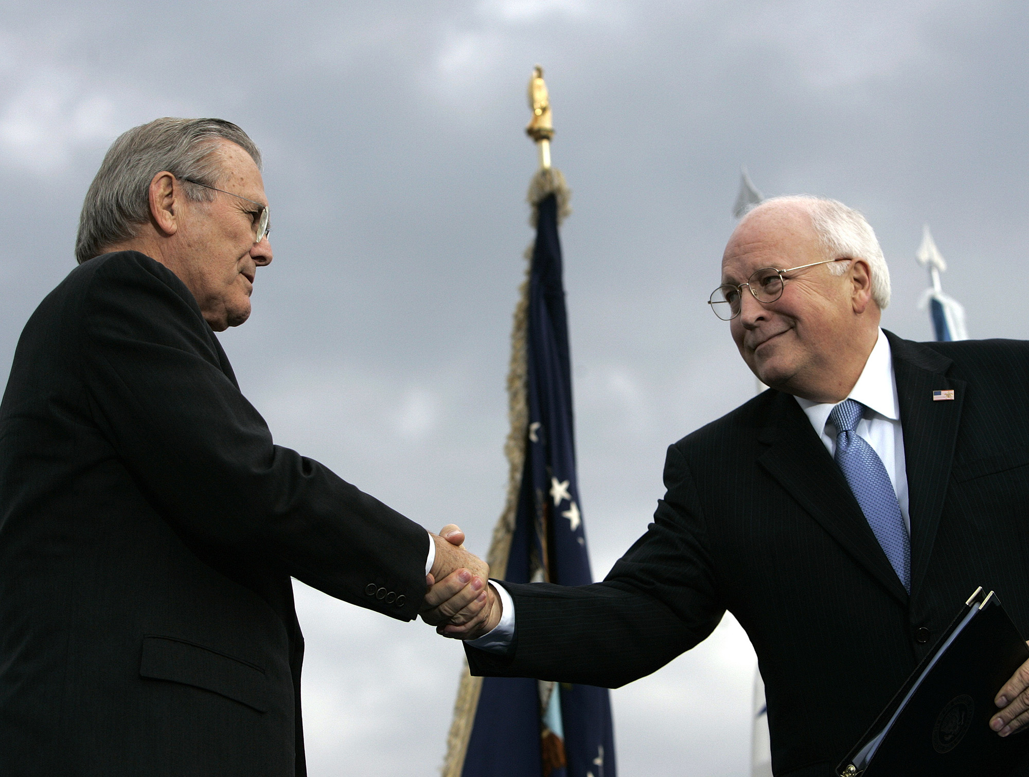 In this Dec. 15, 2006, file photo, outgoing Defense Secretary Donald H. Rumsfeld, left, shakes hands with Vice President Dick Cheney during an Armed Forces Full Honor Review for Rumsfeld at the Pentagon.